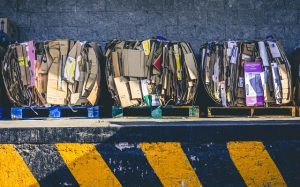 Three Bins Filled With Cardboard Boxes- Benefits Of Hiring A Junk Removal Company Pensacola